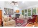 Inviting living room with fireplace, built-in bookcases, and large windows offering views of the lush outdoors at 850 N Langdon, Pittsboro, NC 27312