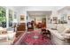 Bright living room with hardwood floors, an open floor plan to the dining area, and large windows at 850 N Langdon, Pittsboro, NC 27312