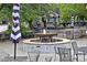 Picturesque outdoor seating area with a charming water fountain and umbrellas at 850 N Langdon, Pittsboro, NC 27312
