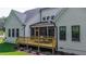 Beautiful home exterior featuring a spacious deck, screened porch, and well-manicured landscaping at 91 Ivy Ridge Rd, Chapel Hill, NC 27516