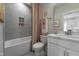 Stylish bathroom with gray tiling, shower-tub combo, and a modern white vanity at 91 Ivy Ridge Rd, Chapel Hill, NC 27516