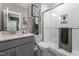 Modern bathroom with walk-in shower, white tile, gray vanity, and stylish fixtures at 91 Ivy Ridge Rd, Chapel Hill, NC 27516