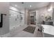 Bright bathroom features a soaking tub, walk-in shower, and a view into the walk-in closet at 91 Ivy Ridge Rd, Chapel Hill, NC 27516
