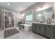 Bright bathroom features dual vanities, a soaking tub, decorative window treatment, and walk-in shower at 91 Ivy Ridge Rd, Chapel Hill, NC 27516