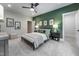 Cozy bedroom with a green accent wall, ceiling fan, and carpet floors offers a relaxing retreat at 91 Ivy Ridge Rd, Chapel Hill, NC 27516