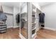 Spacious walk-in closet offering wood floors, full length mirror, and custom built-in shelves at 91 Ivy Ridge Rd, Chapel Hill, NC 27516