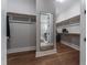 Large walk-in closet featuring wood floors, a full length mirror, and built-in shelving at 91 Ivy Ridge Rd, Chapel Hill, NC 27516