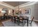 Elegant dining room with a dark wood table, stylish chandelier, and neutral wall colors at 91 Ivy Ridge Rd, Chapel Hill, NC 27516