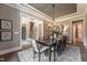 Spacious dining room with a large table, modern chandelier, and open access to other rooms at 91 Ivy Ridge Rd, Chapel Hill, NC 27516