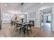 Elegant dining room with a fireplace, stylish lighting, and an open floor plan leading to the kitchen at 91 Ivy Ridge Rd, Chapel Hill, NC 27516