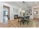 Stylish dining room with fireplace, statement lighting, and decorative accents adjacent to the kitchen at 91 Ivy Ridge Rd, Chapel Hill, NC 27516