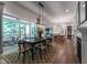 Open-concept dining room with hardwood floors and modern lighting fixtures at 91 Ivy Ridge Rd, Chapel Hill, NC 27516