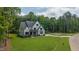 Expansive front yard showcasing a two-story home with a long driveway and tree-lined backdrop at 91 Ivy Ridge Rd, Chapel Hill, NC 27516