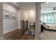 Upstairs hallway with hardwood floors leading into a carpeted bedroom with ceiling fan at 91 Ivy Ridge Rd, Chapel Hill, NC 27516