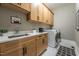 Well-equipped laundry room boasts ample storage, a sink, and modern washer and dryer units at 91 Ivy Ridge Rd, Chapel Hill, NC 27516
