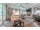Bright living room with coffered ceiling, fireplace with stone surround, and multiple windows at 91 Ivy Ridge Rd, Chapel Hill, NC 27516