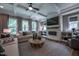 Inviting living room featuring a stone fireplace, built-in shelving, and plenty of natural light at 91 Ivy Ridge Rd, Chapel Hill, NC 27516