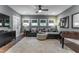 Stylish living room with a comfortable couch, fan, patterned rug, and natural light at 91 Ivy Ridge Rd, Chapel Hill, NC 27516