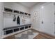 Functional mudroom with custom cubbies, coat hooks, and a built-in bench for added convenience at 91 Ivy Ridge Rd, Chapel Hill, NC 27516