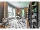 Comfortable home office featuring ample natural light, decorative rug, and custom shelving at 91 Ivy Ridge Rd, Chapel Hill, NC 27516