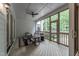 Relaxing screened porch with comfortable seating and views of the surrounding greenery at 91 Ivy Ridge Rd, Chapel Hill, NC 27516