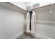 Spacious walk-in closet with built-in shelving and hanging rods for organized storage at 91 Ivy Ridge Rd, Chapel Hill, NC 27516