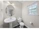 Charming powder room with pedestal sink and decorative mirror at 1003 Crimson Dr, Durham, NC 27713
