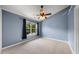 Bedroom features neutral carpet, light-blue walls, and a ceiling fan at 1003 Crimson Dr, Durham, NC 27713