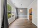 Dining area featuring a large window, hardwood floors, and a pendant light at 1003 Crimson Dr, Durham, NC 27713