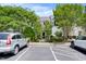 Exterior view of the townhouse with driveway, parking, trees, and landscaping at 1003 Crimson Dr, Durham, NC 27713