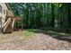 A house with a spacious backyard featuring a wooden deck, and stairs at 1005 Temple St, Raleigh, NC 27609