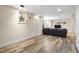 Finished basement with windows, wood floors, and a couch at 1005 Temple St, Raleigh, NC 27609