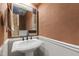 Half bathroom featuring a pedestal sink and decorative mirror at 1005 Temple St, Raleigh, NC 27609