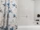 Clean bathtub with shower and blue floral curtain at 1005 Temple St, Raleigh, NC 27609
