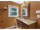 Bathroom featuring a granite countertop, dark wood cabinets, and an framed mirror at 1005 Temple St, Raleigh, NC 27609