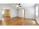 Spacious bedroom featuring hardwood floors, a ceiling fan, and an ensuite bathroom at 1005 Temple St, Raleigh, NC 27609