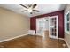 Bedroom with hardwood floors, neutral walls, a ceiling fan, and french doors to another room at 1005 Temple St, Raleigh, NC 27609