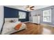 Stylish bedroom featuring hardwood floors, a ceiling fan, and a large window at 1005 Temple St, Raleigh, NC 27609