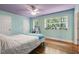 Cozy bedroom with wood floors, two windows, and desk at 1005 Temple St, Raleigh, NC 27609