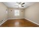 Bedroom featuring hardwood floors, neutral walls, and a ceiling fan at 1005 Temple St, Raleigh, NC 27609