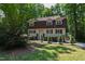 Charming two-story home with a well-manicured lawn and mature trees providing shade at 1005 Temple St, Raleigh, NC 27609