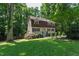 Traditional two-story home surrounded by lush greenery, offering a serene and private setting at 1005 Temple St, Raleigh, NC 27609