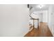 Hallway with hardwood floors leading to the upper level and other living spaces at 1005 Temple St, Raleigh, NC 27609