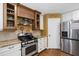 Kitchen featuring stainless steel appliances, granite countertops, and wooden cabinets at 1005 Temple St, Raleigh, NC 27609
