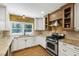Well-lit kitchen featuring granite counters, stainless steel appliances, and wooden cabinets at 1005 Temple St, Raleigh, NC 27609