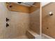 An updated shower with bronze fixtures, a built-in bench, and neutral tiling at 1005 Temple St, Raleigh, NC 27609