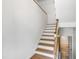 Staircase with wooden banister and wood floors at 1005 Temple St, Raleigh, NC 27609