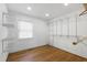 Spacious walk-in closet featuring wood floors, shelving, and a window for natural light at 1005 Temple St, Raleigh, NC 27609