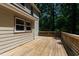 Exterior wooden deck with siding and a wooded backdrop at 1005 Temple St, Raleigh, NC 27609