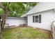 Spacious backyard with some grass and a door to the home at 102 S College Ave, Kenly, NC 27542